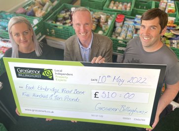 Chris Burton (centre) present East Elmbridge Foodbank with £510